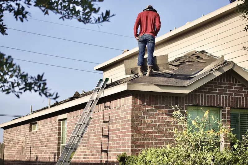 Professional roofer working on a residential roof in Baltic
